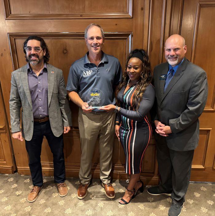 Paul Olszewski receives the Veteran Entrepreneur of the Year Award from New York SBDC State Director Sonya Smith. Also pictured are Dan Rickman of the SBA (left) and Bob Griffin of the North Central SBDC (right).