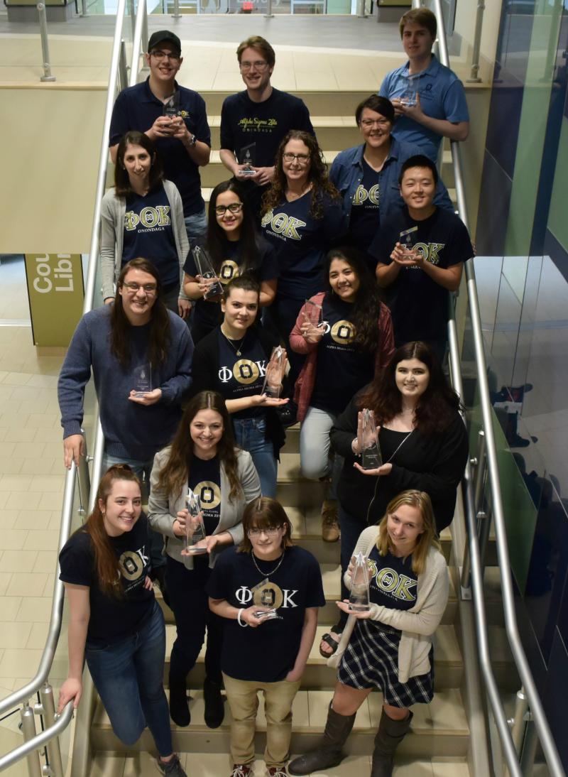 OCC's Phi Theta Kappa honor society students and administrators show off the trophies they won at PTK's annual conference in Florida. They are pictured on the main stairwell inside Coulter Hall.
