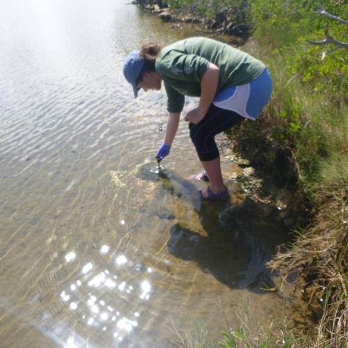 A student taking a water sample