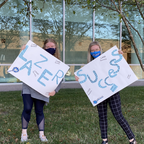 Student & Employee with Lazer Success Signs