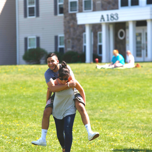 Students goofing around on the lawn