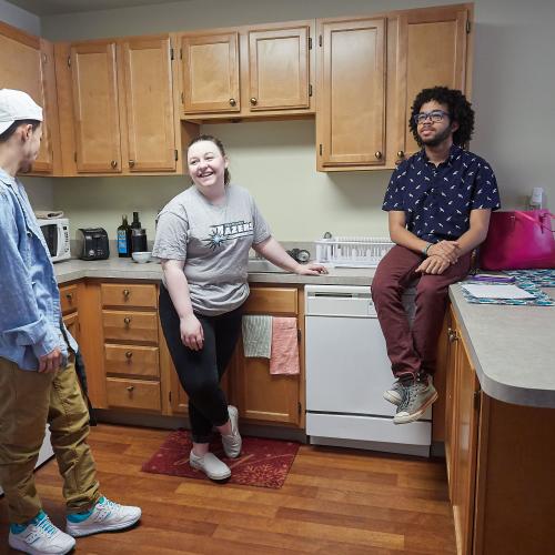 Students hanging out in a suite kitchen