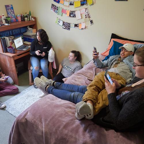 Students hanging out in a bedroom