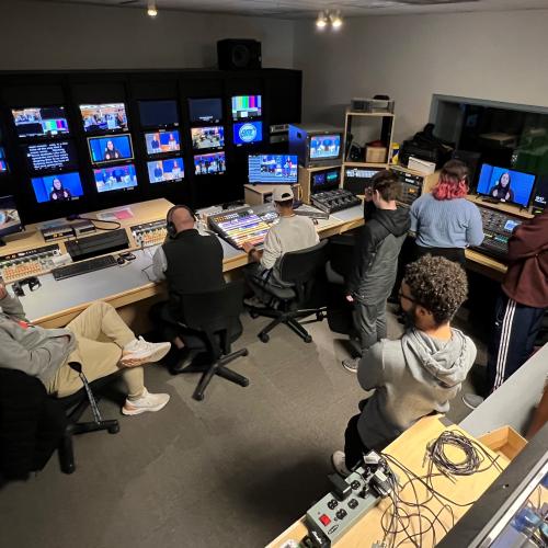 Professor Mark Ballard (wearing headset) leads students through a television production in the Broadcast Media Communication studios in the Whitney Applied Technology Center.