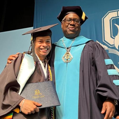 OCC President Dr. Warren Hilton (right) hugged Student Commencement Speaker Shayne Turo (left) after handing him his degree.
