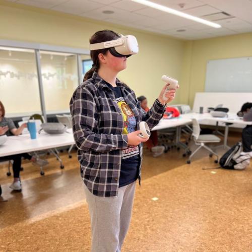 Onondaga Community College student McKenzie Anderson uses a virtual reality headset in her Introduction to Health Professions class. "It opened my eyes to the different types of setting you can work in and what would be the best fit for me," she said.