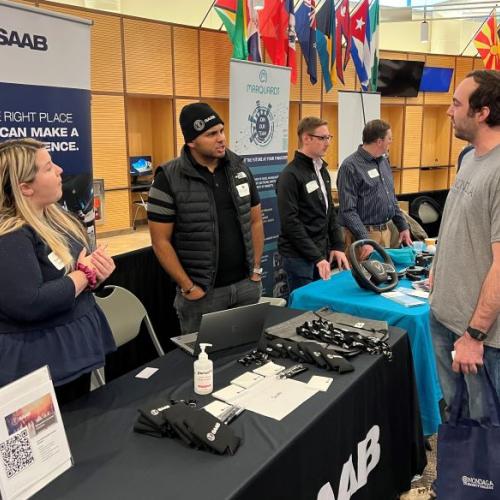 OCC Computer Science major Liam Chavis (right) spoke with representatives of Saab, Inc. at the STEM Showcase in the Gordon Student Center.