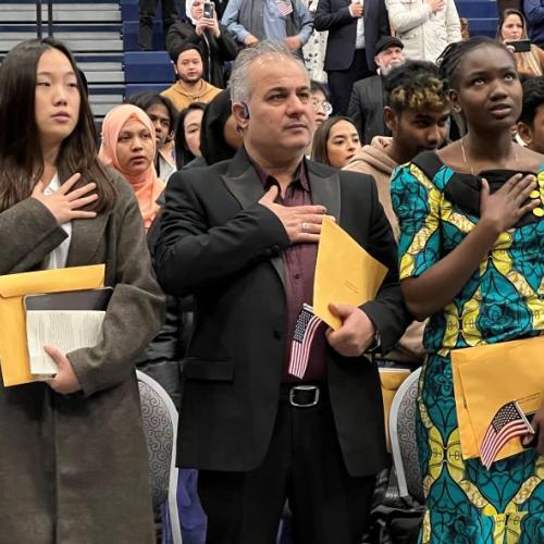 New American citizens recite the Pledge of Allegiance during a Naturalization ceremony held November 9 in the SRC Arena.