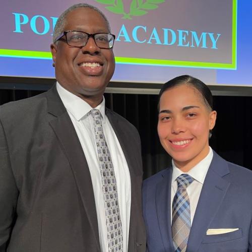 OCC President Dr. Warren Hilton (left) congratulated Nadia Diaz '20 (right) on becoming a new Syracuse Police Officer. She was sworn-in during a ceremony in Storer Auditorium.