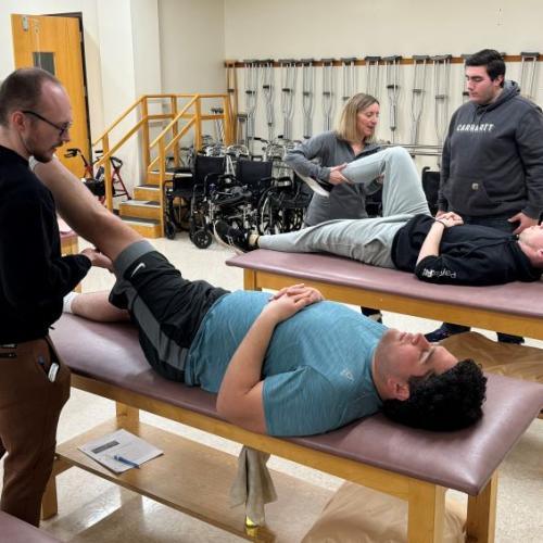 Professor Kristen Lounsbery PT, DPT, NSEd, ACCE works with students in the Physical Therapists Assistant lab in Ferrante Hall. Students who graduated from the program in 2023 achieved a 100% pass rate on the national exam which is well above the nationwide average.