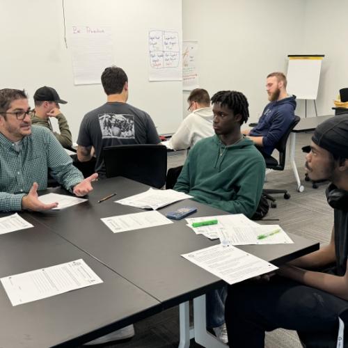 Professor Johnathon Sly (left) works with students in his ELM 100 (Electromechanical Technology) class during the fall 2024 semester..