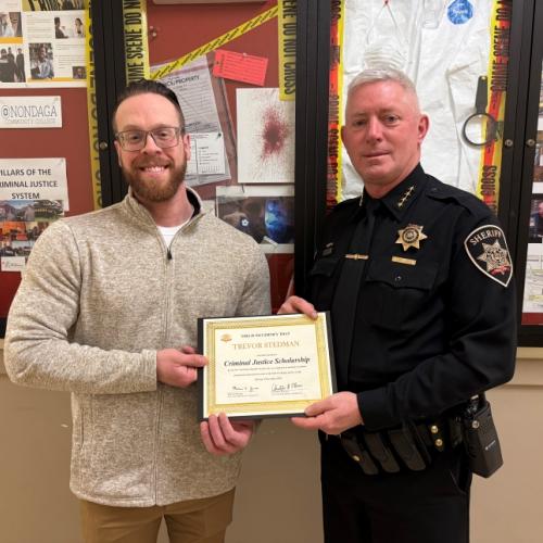 OCC Student Trevor Stedman receives the Criminal Justice Scholarship from Onondaga County Sheriff Toby Shelley.