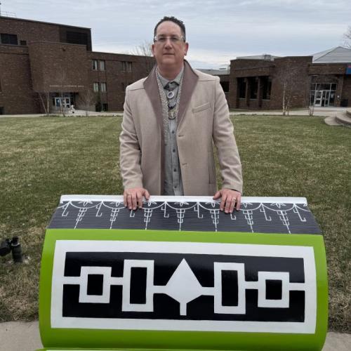 Brandon Lazore '14 is pictured with his bench on Onondaga Community College's quad. 