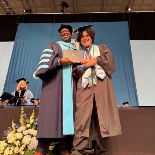 Yesvier Aviles Mendez (right) receives his Physical Therapist Assistant degree from OCC President Dr. Warren Hilton (left).