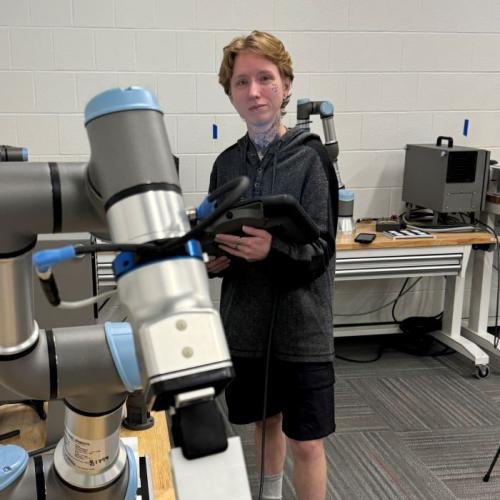 Dio Brown is a 35-year-old OCC student who is about to complete the Electromechanical Technology degree program, then pursue a bachelor's degree tuition-free. Dio is pictured in the robotics lab in the Whitney Applied Technology Center.