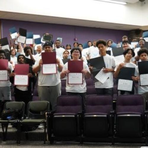 Syracuse City School District students show off their certificates during a P-TECH signing ceremony in OCC's Storer Auditorium.