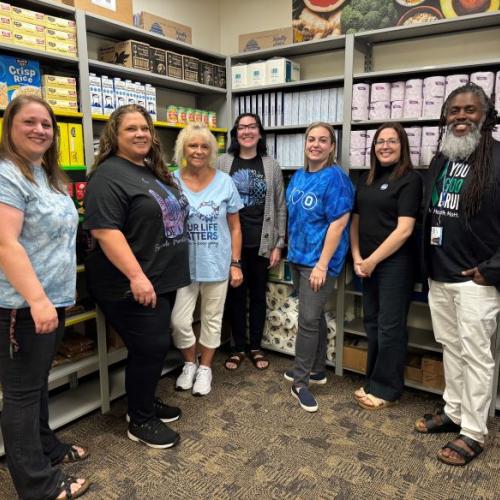 The Counseling and Community Care Hub staff is pictured in the food pantry in the Gordon Student Center.