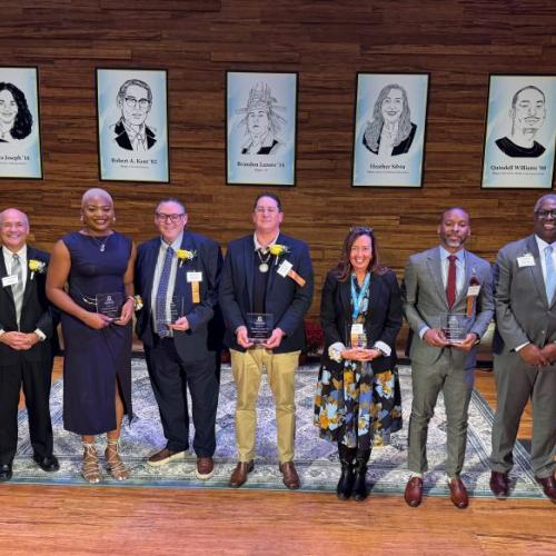 Left to right: event emcee Glenn LaPoint '16, Chidera Joseph '16, Rob Kent '82, Brandon Lazore '14, Heather Silvia '90, Quindell Williams '08, OCC President Dr. Warren Hilton.