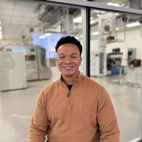 RJ Tinsley '25 is pictured in front of OCC's Micron Cleanroom Simulation Lab. Tinsley is a Dry Etch Process Technician at Micron in Boise, Idaho. He visited campus in October and saw OCC's new facilities for the first time.