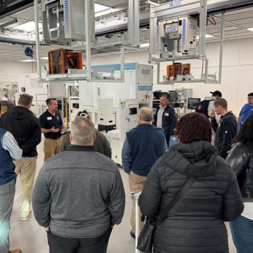 Professor Mike Grieb speaks with industry partners in the Micron Cleanroom Simulation Lab on the Onondaga Community College campus.