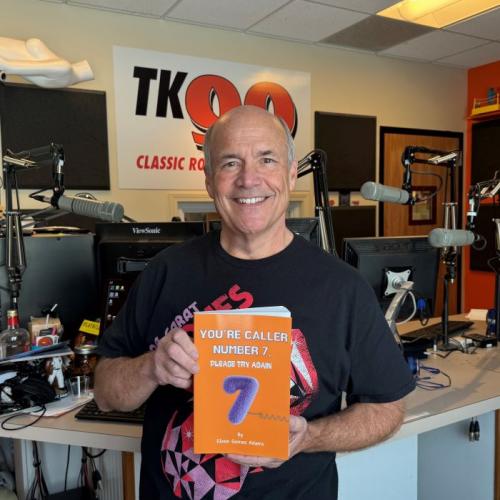 Glenn LaPoint '14 shows off his new book in the studios of radio station TK-99 where he's been a staple of Central new York entertainment for more than 30 years.