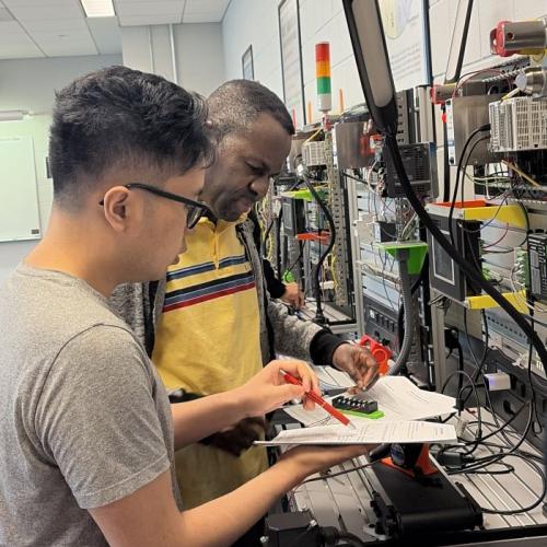 Aaron Unger (left) and Cyrille Kayembe Asagnion (right) work together during the Semiconductor Bootcamp.