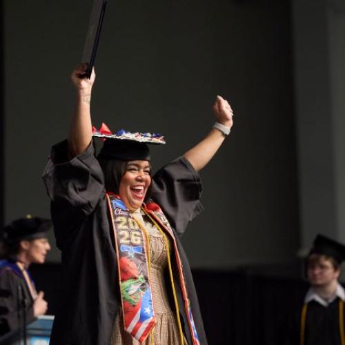 Students celebrated reaching the finish line as they crossed the stage in the SRC Arena during Onondaga Community College's commencement ceremony.