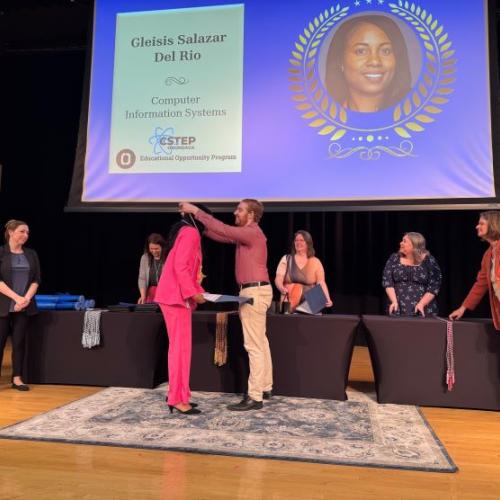 Graduating student Gleisis Salazar Del Rio receives her Educational Opportunity Program cord from Student Navigator Hunter Overstreet during the opportunity program's graduation celebration.