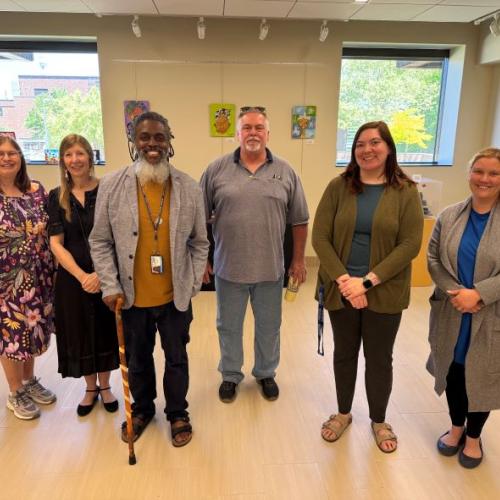 Onondaga Community College faculty and staff gathered for a reception celebrating their "On My Own Time" art exhibit.