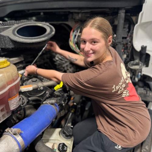 Alaina Kelsey is one of the top students in Onondaga Community College's Automotive Technology and Commercial/Heavy Equipment Service Repair degree programs. She's pictured working on a 2023 Freightliner in the College's new Commercial/Heavy Equipment Service Repair garage.
