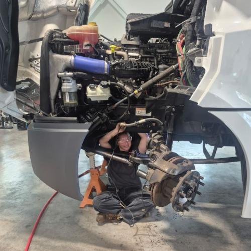Alaina Kelsey is enjoying her hands-on learning opportunities in Onondaga Community College's new Commercial/Heavy Equipment Service Repair program. She's working on a 2023 Frieghtliner truck that was loaned to OCC by Tracey Road Equipment.