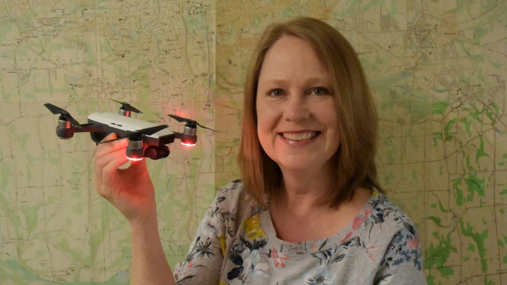 Photo of OCC Professor Buffy Quinn holding a drone Photo of OCC Professor Buffy Quinn holding a drone