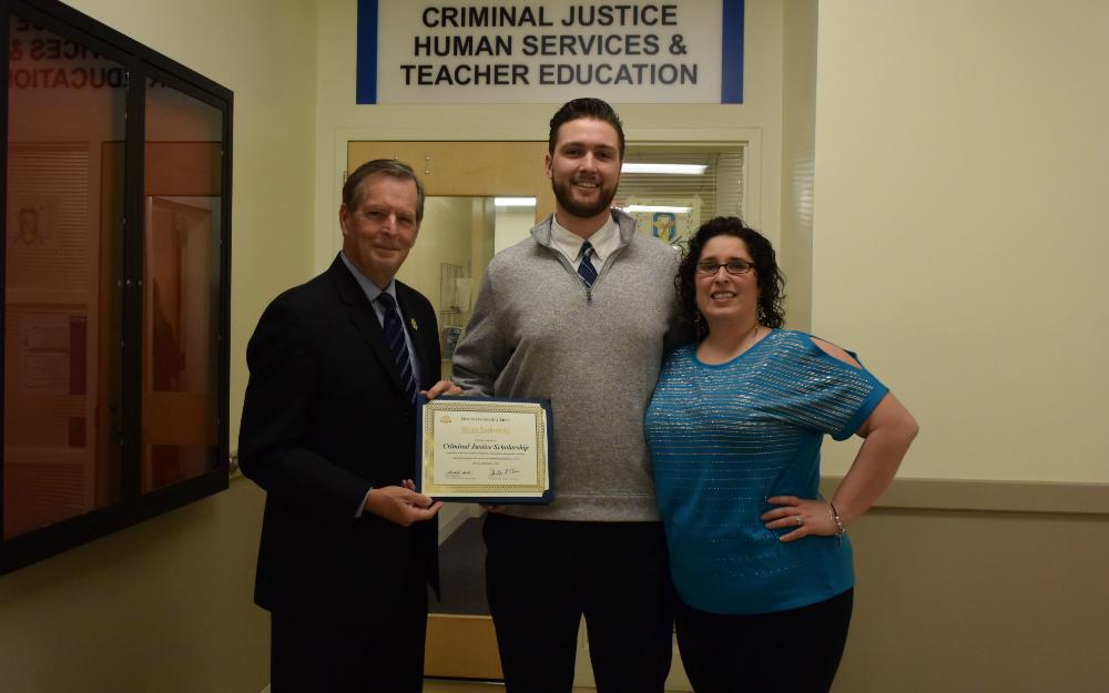 OCC Criminal Justice major Brian Jankowski (center) receives a scholarship check and certificate from Onondaga County Sheriff Gene Conway (left). Also pictured is Professor Jessica Wieczorek of OCC's Criminal Justice & Public Safety Department. OCC Criminal Justice major Brian Jankowski (center) receives a scholarship check and certificate from Onondaga County Sheriff Gene Conway (left). Also pictured is Professor Jessica Wieczorek of OCC's Criminal Justice & Public Safety Department.