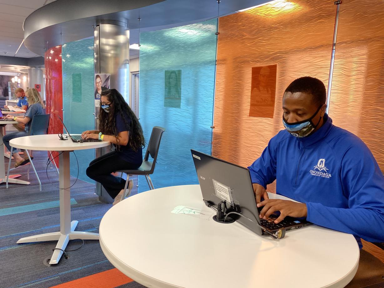 Two individuals sitting at computers in the campus Learning Center