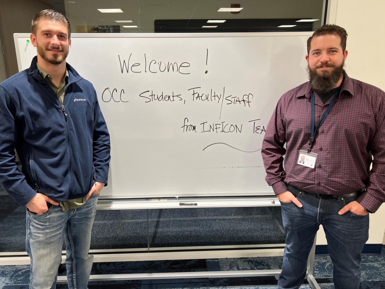 Layne Bolton (left) and Mike Burst (right) are graduates of OCC's Mechanical Technology degree program who recently welcomed current students to Inficon. The company is expanding to a 24/7 operation and needs skilled workers.