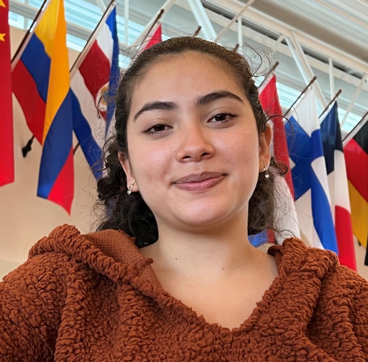 Esteffany Lorena Castillo-Patino is pictured in front of her native flag of Columbia (yellow, blue, and red stripes) in the Gordon Student Center. Esteffany Lorena Castillo-Patino is pictured in front of her native flag of Columbia (yellow, blue, and red stripes) in the Gordon Student Center.