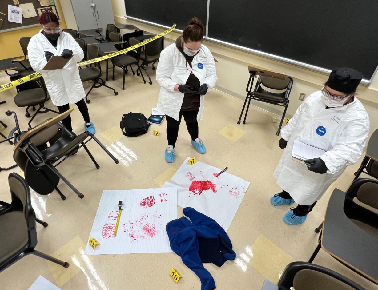  Students in the Criminal Investigations class collect evidence at a mock crime scene in Mawhinney Hall.