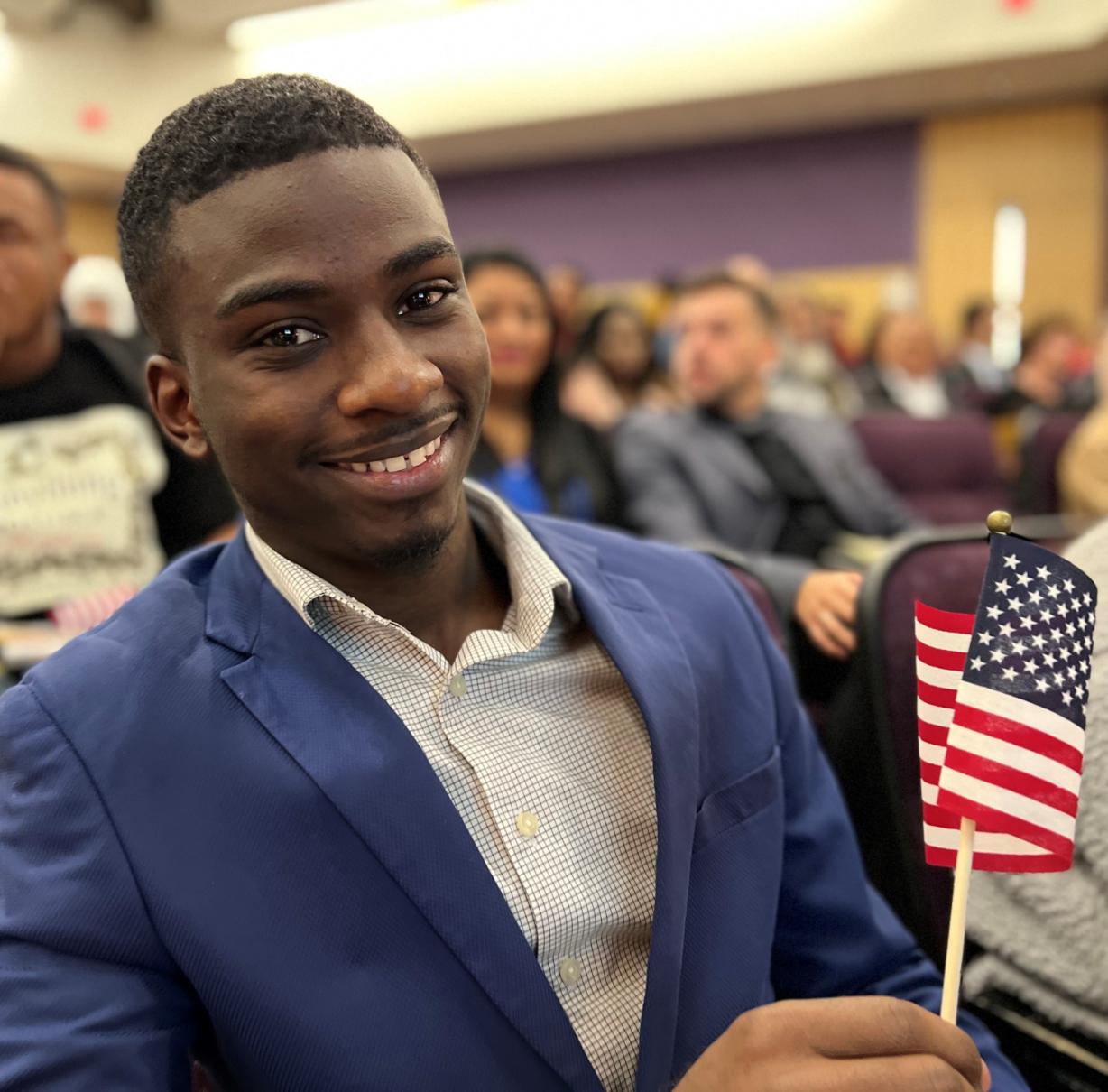 Onondaga Community College student Juhudi Boazi became an American citizen during a Naturalization Ceremony October 18 in Storer Auditorium. Onondaga Community College student Juhudi Boazi became an American citizen during a Naturalization Ceremony October 18 in Storer Auditorium.