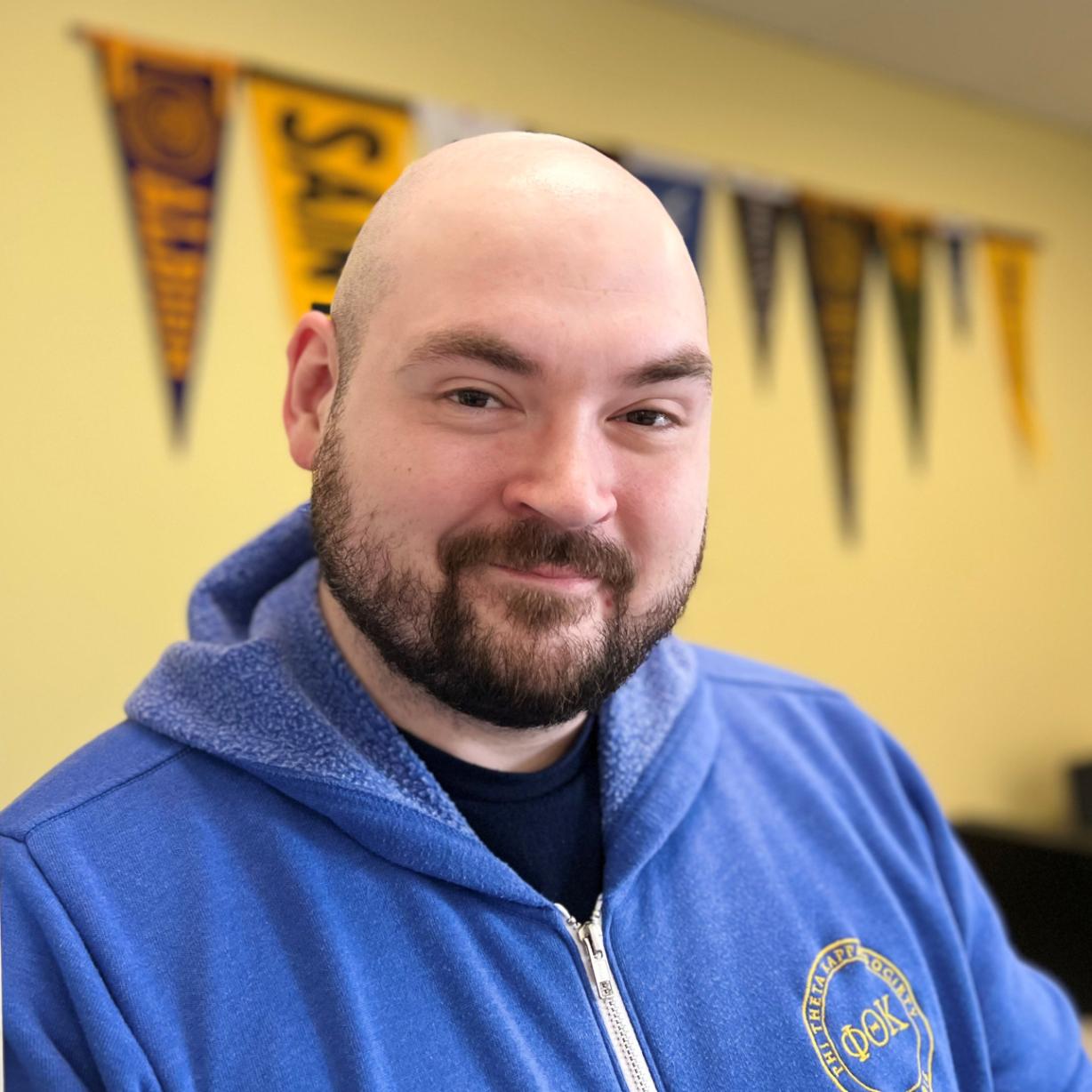 Brandon Bell is a 35-year-old student in the Cybersecurity degree program. He's also a member of the Phi Theta Kappa Honor Society's Leadership Team. He's pictured in the PTK Suite in Coulter Hall.