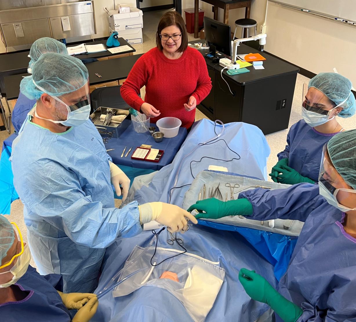 Surgical Technology Program Director Dorothy Dobrowolski BS, CST works with students in class. OCC is now accepting a new group of students for the spring 2023 semester. 