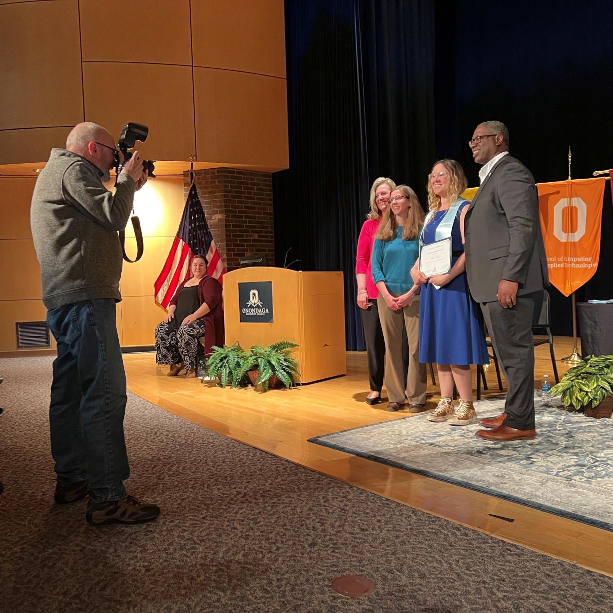 Student Sam Moore (wearing blue stole and holding certificate) receives Curriculum Honors in the Mathematics & Science degree program. She's pictured with (left to right) Provost Anastasia Urtz, Professor Maryann Page, and President Warren Hilton. Student Sam Moore (wearing blue stole and holding certificate) receives Curriculum Honors in the Mathematics & Science degree program. She's pictured with (left to right) Provost Anastasia Urtz, Professor Maryann Page, and President Warren Hilton.