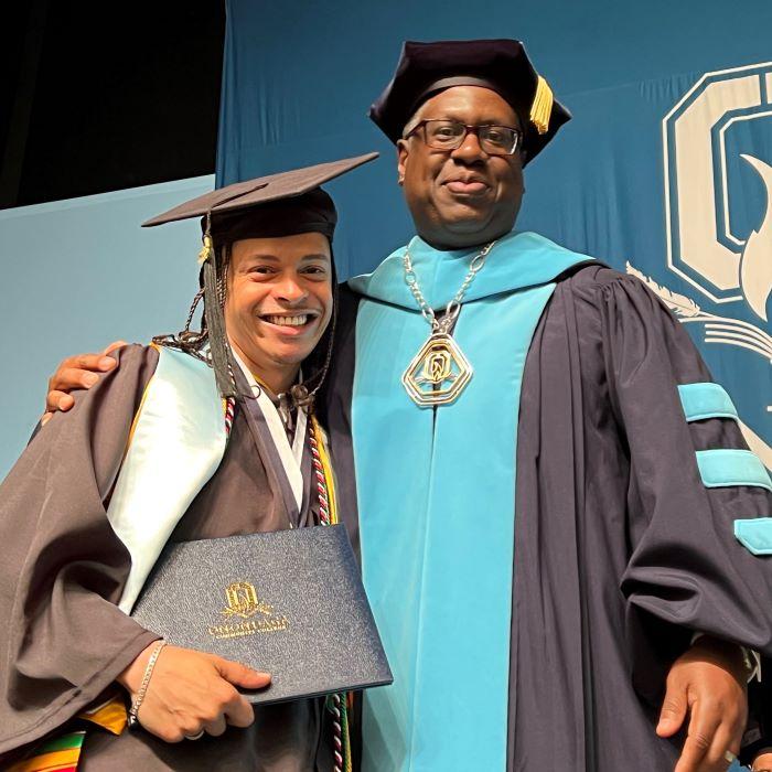 OCC President Dr. Warren Hilton (right) hugged Student Commencement Speaker Shayne Turo (left) after handing him his degree. OCC President Dr. Warren Hilton (right) hugged Student Commencement Speaker Shayne Turo (left) after handing him his degree.