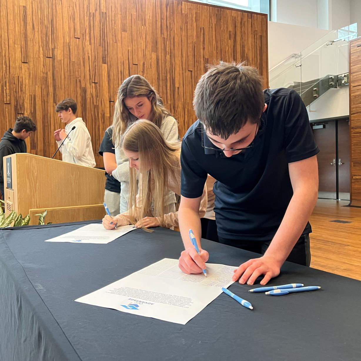 Students from Jordan-Elbridge High School sign up for the OCC Advantage program during a ceremony in the Recital Hall on Campus.