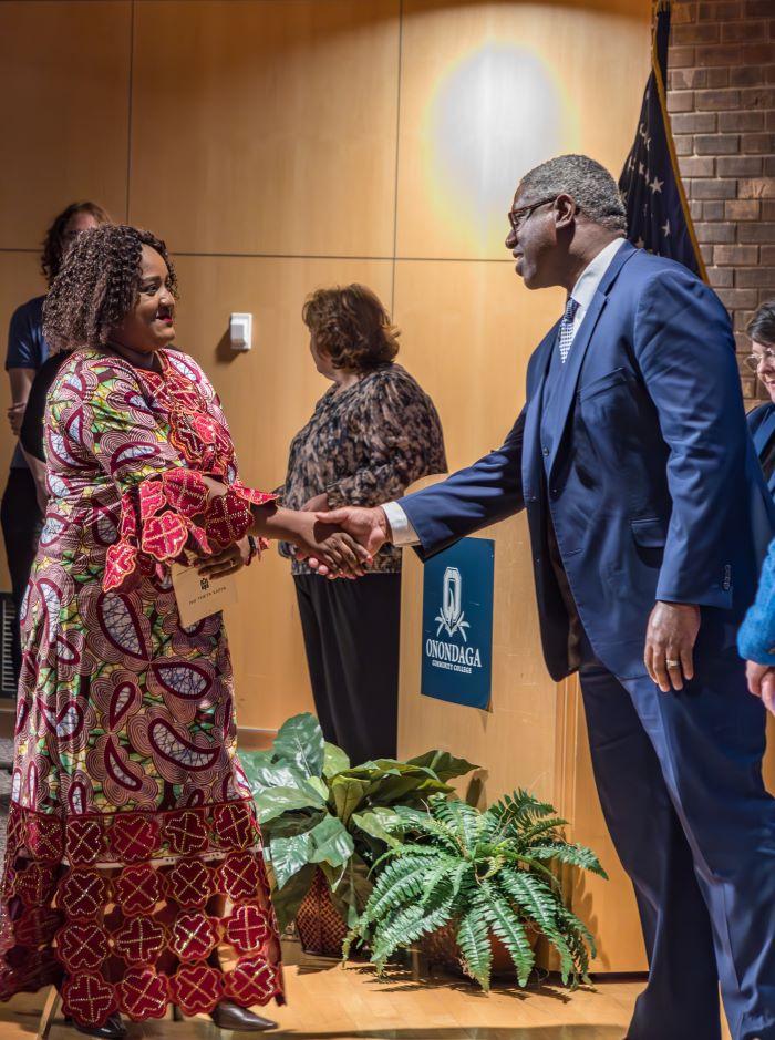 Nursing student Lieve Marie-Claire Kitsa (left) is welcomed into the Phi Theta Kappa Honor Society by OCC President Dr. Warren Hilton (right). Nursing student Lieve Marie-Claire Kitsa (left) is welcomed into the Phi Theta Kappa Honor Society by OCC President Dr. Warren Hilton (right).