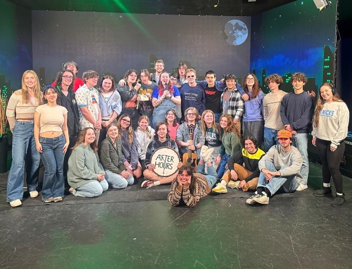 Kyle Goff '23 (holding After Hours sign) is pictured at Ithaca College where he is a senior in the Television and Digital Media Production program.