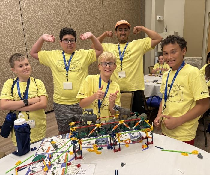 Students celebrated their successful bridge building experience during Micron-sponsored Chip Camp. OCC class of 2024 member Alex Espitia-Casallas (wearing cap) worked with students during the exercise. Students celebrated their successful bridge building experience during Micron-sponsored Chip Camp. OCC class of 2024 member Alex Espitia-Casallas (wearing cap) worked with students during the exercise.