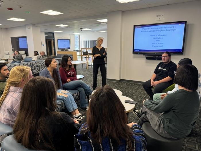 Professor Katharine Rumrill-Teece (standing) listens to a small group discussion in the new Innovative Learning Lab.
