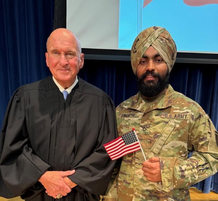 Gursewak Singh (right) a member of the United States Army, became an American citizen during a Naturalization Ceremony presided over by U.S. Magistrate Judge Honorable David E. Peebles (left). Gursewak Singh (right) a member of the United States Army, became an American citizen during a Naturalization Ceremony presided over by U.S. Magistrate Judge Honorable David E. Peebles (left).