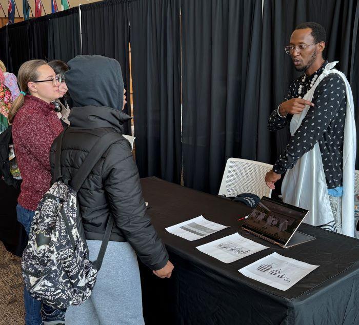 Onondaga Community College student Noel Ponthuit tells fellow students about his native Rwanda at the World Languages &amp; Cultural Fair.