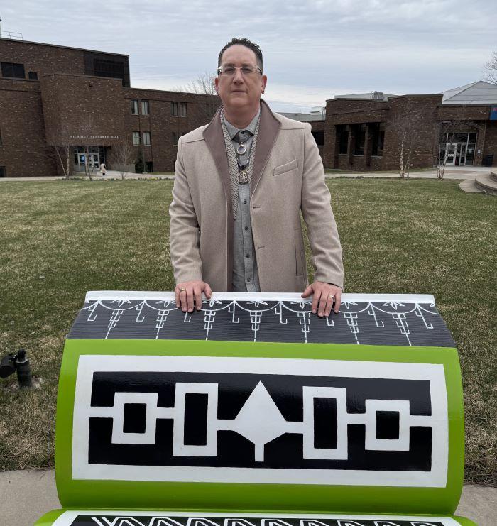 Brandon Lazore '14 is pictured with his bench on Onondaga Community College's quad.